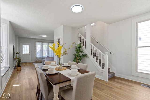 2005 Carrollton Ave, Indianapolis, IN 46202 - dining area with baseboards, stairs, and light wood finished floors