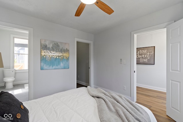 2005 Carrollton Ave, Indianapolis, IN 46202 - bedroom with ensuite bathroom, baseboards, wood finished floors, and a ceiling fan