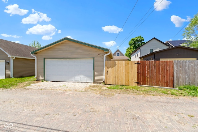 2005 Carrollton Ave, Indianapolis, IN 46202 - view of front facade with fence, an outbuilding, and a garage