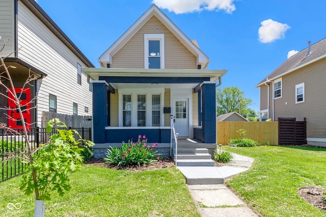 2005 Carrollton Ave, Indianapolis, IN 46202 - shotgun-style home featuring a porch and brick siding