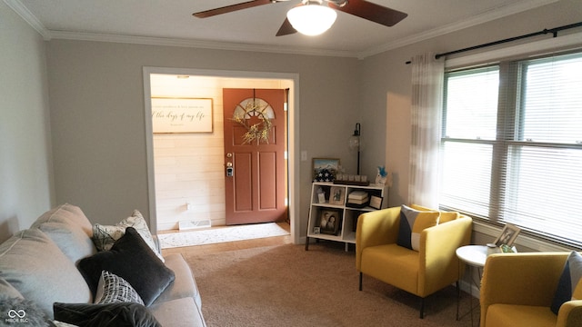 interior space featuring carpet floors, ornamental molding, and a ceiling fan