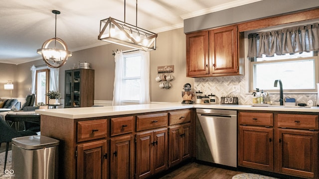 kitchen with stainless steel dishwasher, a peninsula, dark wood-style floors, a sink, and a notable chandelier