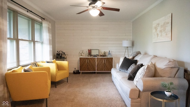 carpeted living area featuring crown molding and a ceiling fan