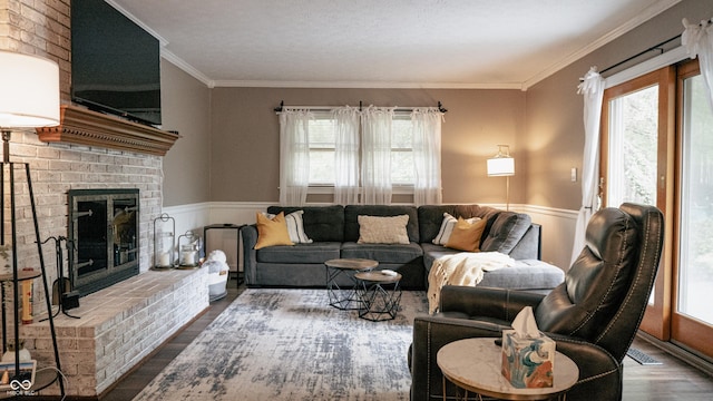 living room featuring crown molding, wood finished floors, and a healthy amount of sunlight