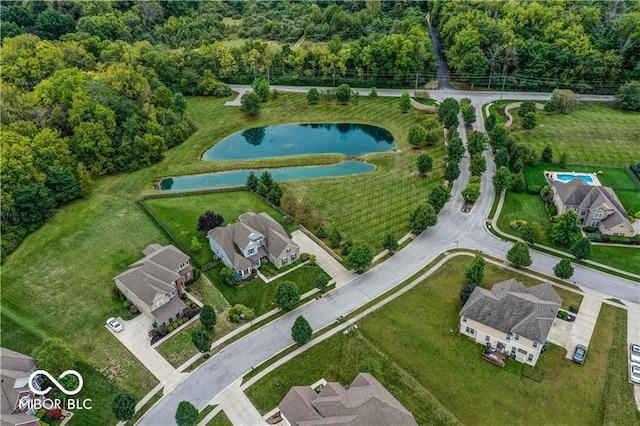 bird's eye view featuring a water view and a wooded view