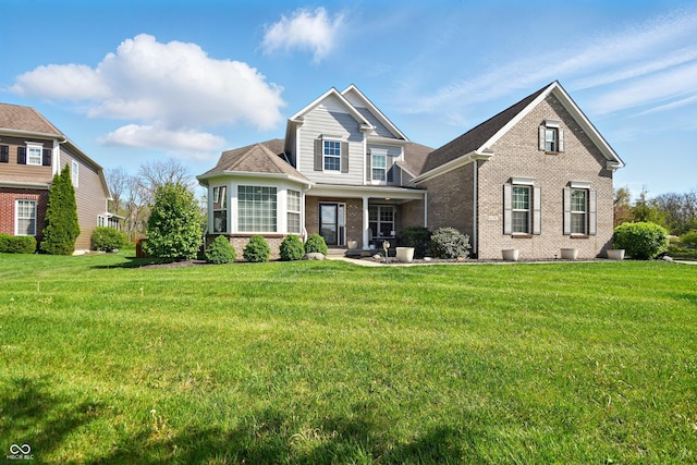 view of front facade featuring a front lawn and brick siding