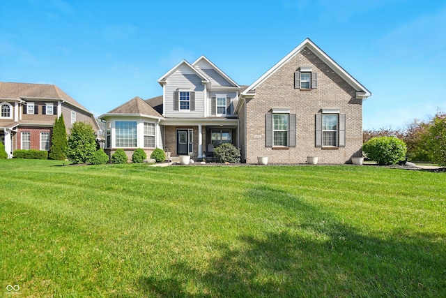 craftsman house with brick siding and a front lawn