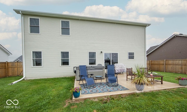 3235 Myrtle Dr, Lapel, IN 46051 - rear view of house with a patio, a hot tub, a fenced backyard, and a lawn