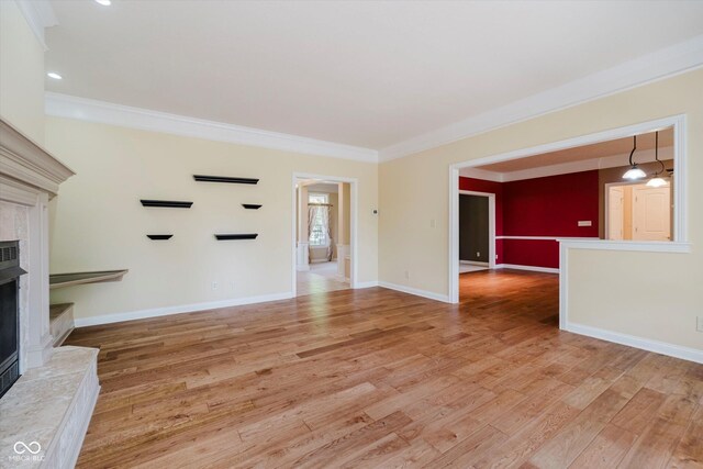 6345 Canak Dr, Avon, IN 46123 - unfurnished living room featuring a premium fireplace, ornamental molding, light wood-style floors, baseboards, and recessed lighting