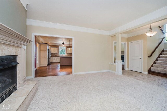 6345 Canak Dr, Avon, IN 46123 - unfurnished living room with carpet floors, a fireplace, ornamental molding, stairway, and baseboards