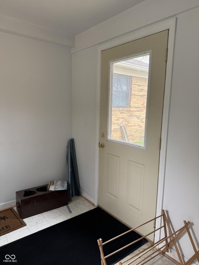 doorway featuring baseboards