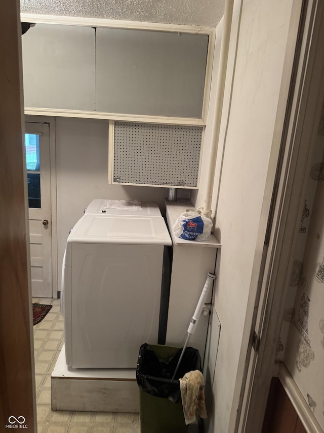 laundry room featuring light floors, washer and dryer, and laundry area