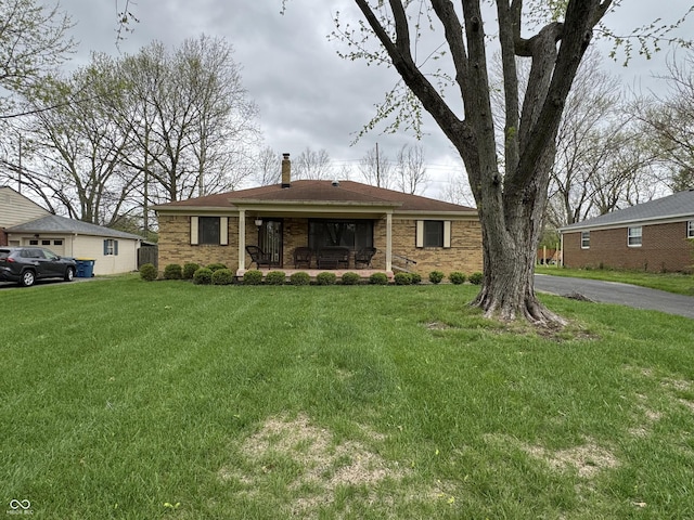 ranch-style home with a chimney and a front yard