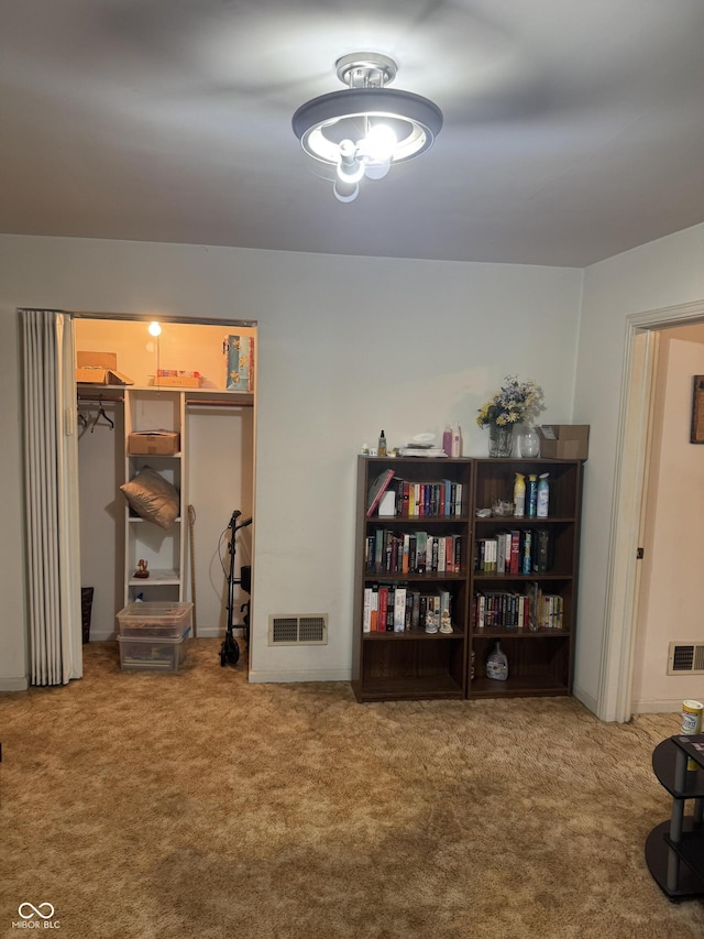 interior space with carpet floors and visible vents