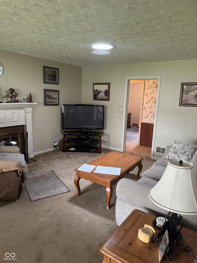 living room featuring a textured ceiling, carpet, baseboards, a brick fireplace, and visible vents