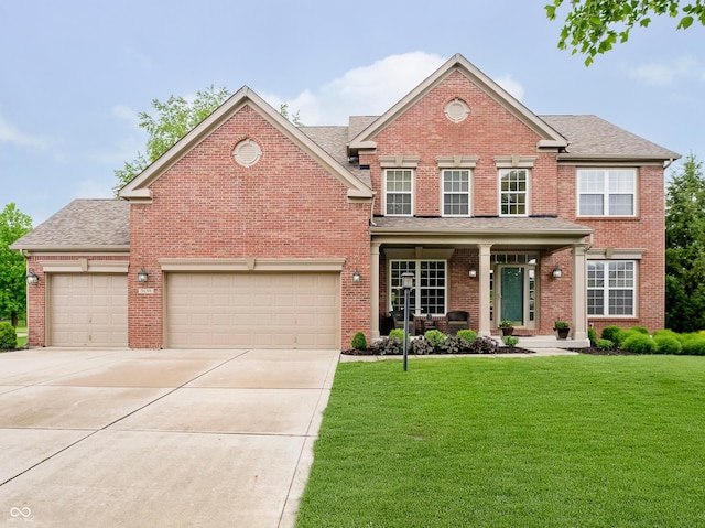 5698 Kenderly Ct, Carmel, IN 46033 - view of front of house with brick siding, a front lawn, driveway, and an attached garage