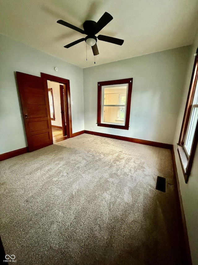 11 Highland St, Greencastle, IN 46135 - unfurnished bedroom featuring baseboards, ensuite bathroom, ceiling fan, and carpet