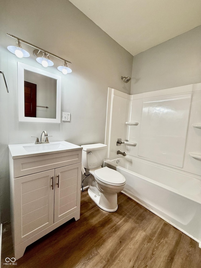 11 Highland St, Greencastle, IN 46135 - bathroom with toilet, vanity, bathtub / shower combination, and wood finished floors