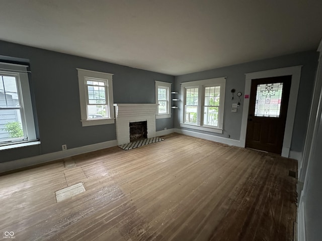 532 S 6th St, Clinton, IN 47842 - unfurnished living room with wood finished floors, a fireplace, and baseboards