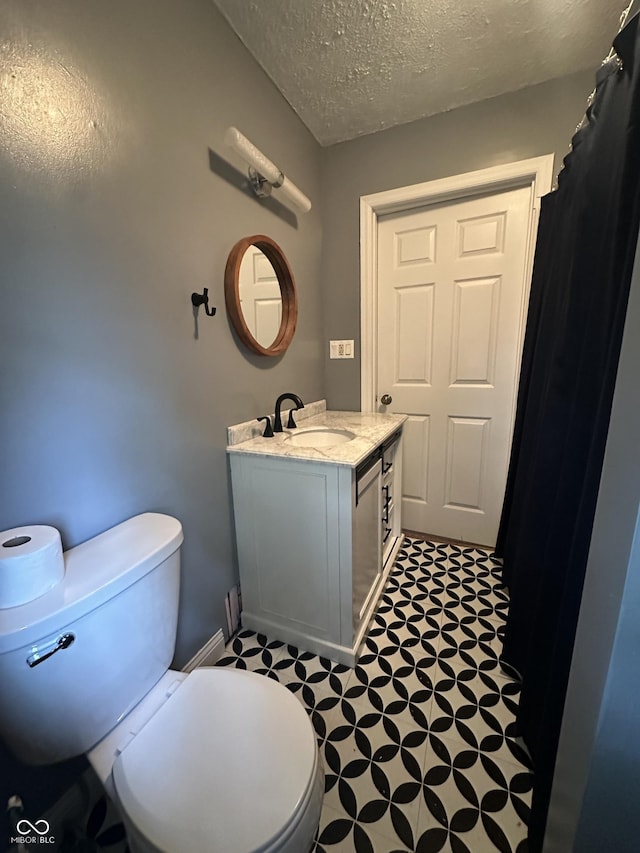 532 S 6th St, Clinton, IN 47842 - full bathroom featuring toilet, vanity, tile patterned floors, and a textured ceiling