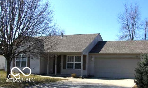 single story home with an attached garage and driveway