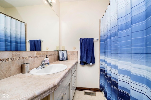 full bathroom with a shower with curtain, tile patterned floors, visible vents, baseboards, and vanity