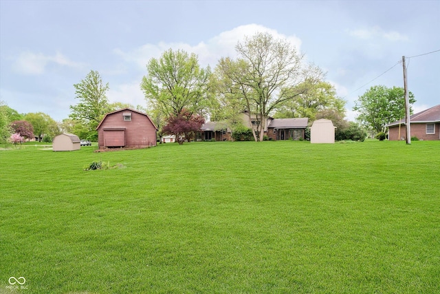 view of yard featuring a storage shed, an outdoor structure, and a barn