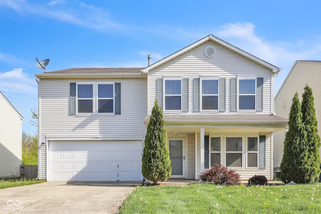 12704 Bearsdale Dr, Indianapolis, IN 46235 - traditional home featuring an attached garage, concrete driveway, and a front lawn