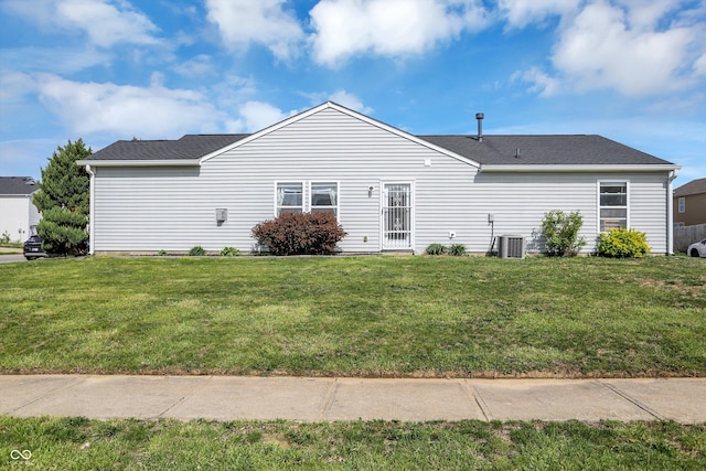 back of house with a lawn and central AC unit
