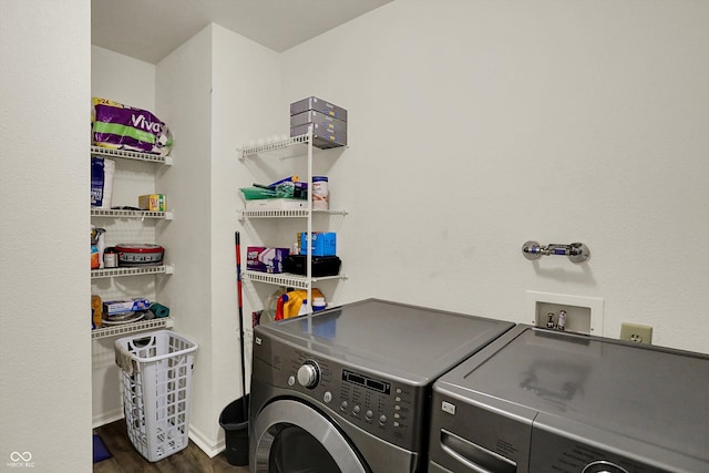laundry room featuring dark wood-type flooring, baseboards, independent washer and dryer, and laundry area