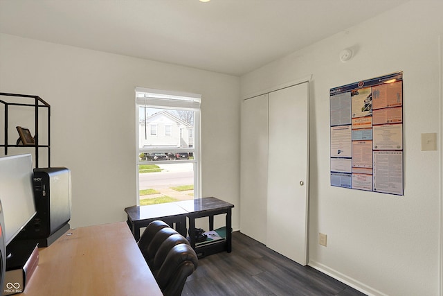 office space featuring baseboards and dark wood finished floors