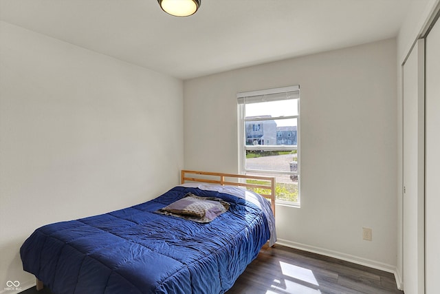 bedroom featuring baseboards and wood finished floors