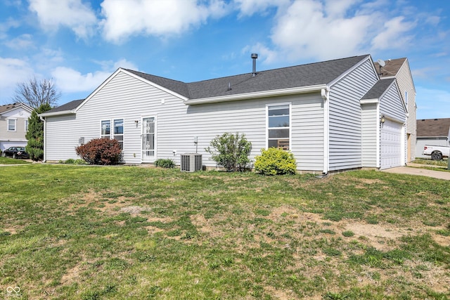 view of home's exterior featuring an attached garage, driveway, a yard, and central AC unit