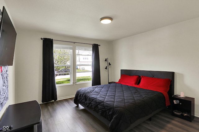 bedroom with wood finished floors and baseboards