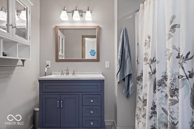 bathroom featuring baseboards and vanity