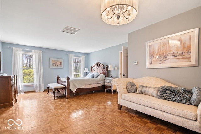 bedroom with baseboards and a chandelier