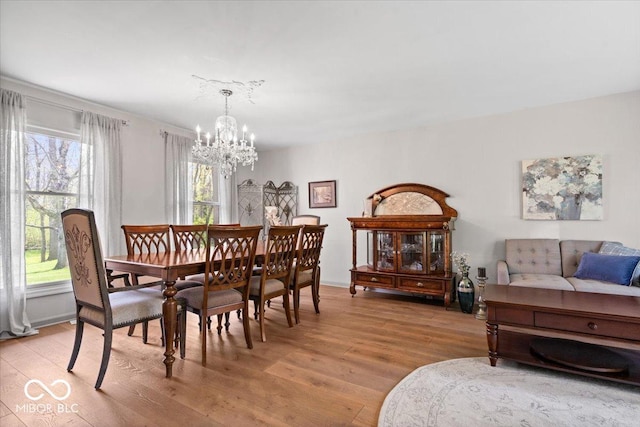 dining space featuring an inviting chandelier and light wood-style floors