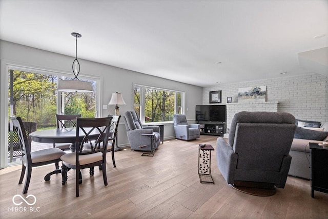 interior space with brick wall and light wood-style floors