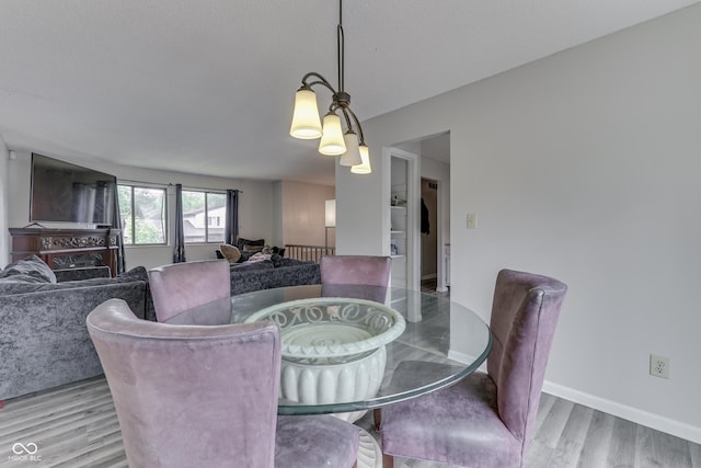5335 Honey Comb Ln, Indianapolis, IN 46221 - dining room featuring wood finished floors, a chandelier, and baseboards