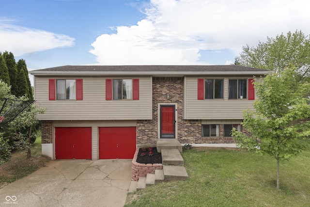 5335 Honey Comb Ln, Indianapolis, IN 46221 - raised ranch featuring brick siding, driveway, a garage, and a front yard