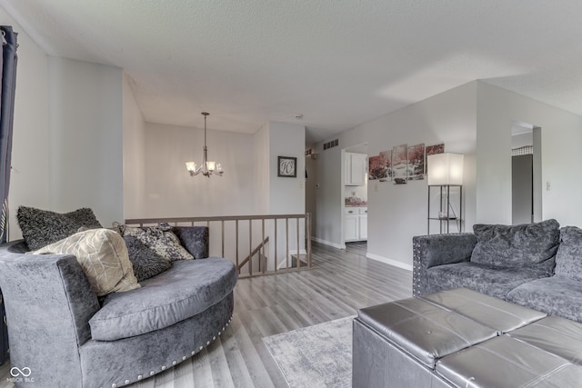 5335 Honey Comb Ln, Indianapolis, IN 46221 - living area featuring a chandelier, light wood-type flooring, and baseboards