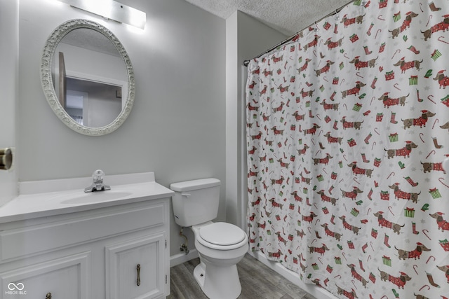 5335 Honey Comb Ln, Indianapolis, IN 46221 - full bathroom featuring toilet, a textured ceiling, wood finished floors, vanity, and a shower with curtain
