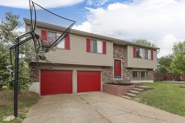 5335 Honey Comb Ln, Indianapolis, IN 46221 - split foyer home featuring brick siding, an attached garage, concrete driveway, and a front lawn