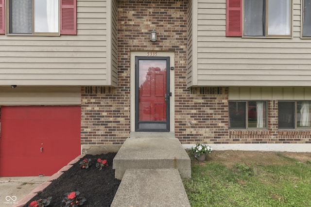 5335 Honey Comb Ln, Indianapolis, IN 46221 - view of exterior entry featuring brick siding and an attached garage