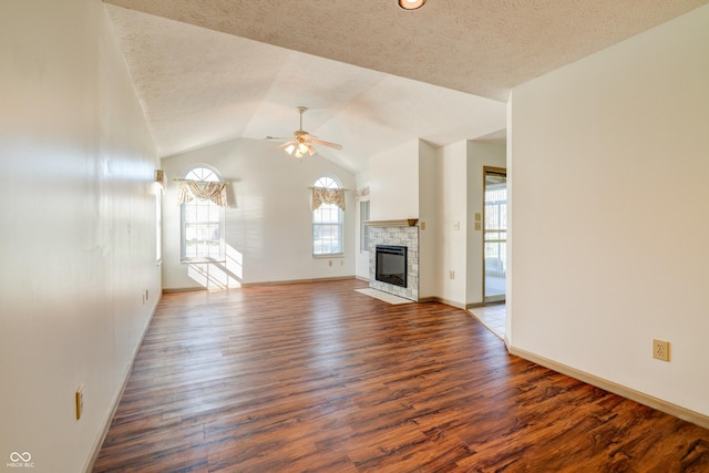 5839 Quail Run Dr, Indianapolis, IN 46237 - unfurnished living room featuring a glass covered fireplace, ceiling fan, wood finished floors, and lofted ceiling