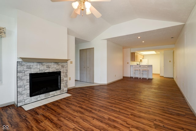5839 Quail Run Dr, Indianapolis, IN 46237 - unfurnished living room with ceiling fan, a fireplace, baseboards, wood finished floors, and lofted ceiling