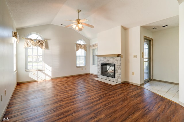 5839 Quail Run Dr, Indianapolis, IN 46237 - unfurnished living room with visible vents, wood finished floors, a fireplace, a ceiling fan, and vaulted ceiling
