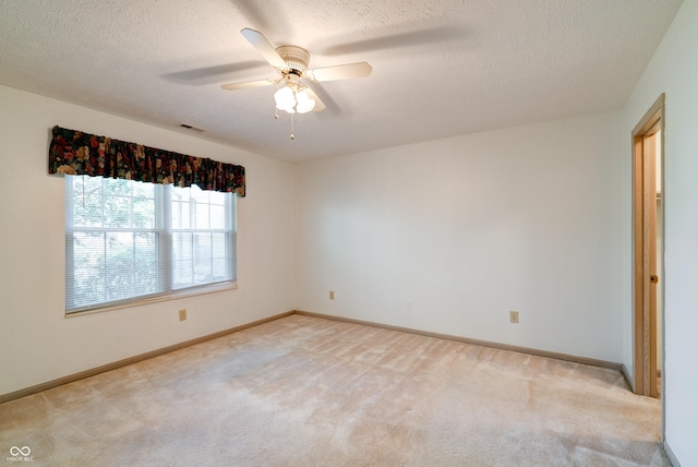 5839 Quail Run Dr, Indianapolis, IN 46237 - unfurnished room with ceiling fan, a textured ceiling, light colored carpet, visible vents, and baseboards