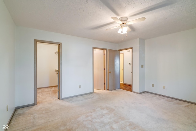 5839 Quail Run Dr, Indianapolis, IN 46237 - unfurnished bedroom featuring a ceiling fan, baseboards, a spacious closet, and light carpet