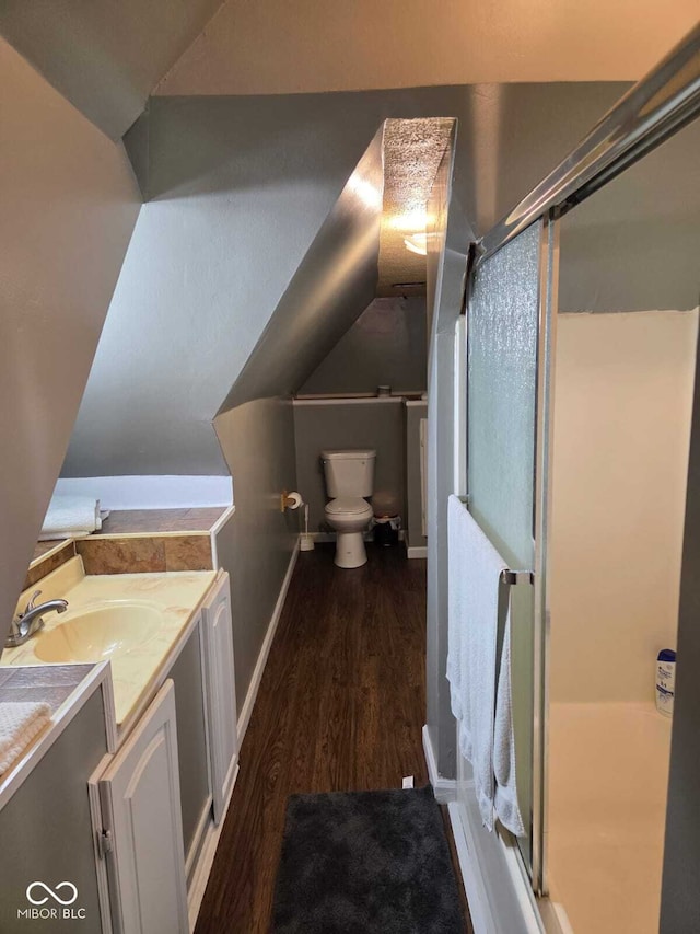 2819 W 16th St, Indianapolis, IN 46222 - bathroom with vanity, a shower stall, toilet, and wood finished floors